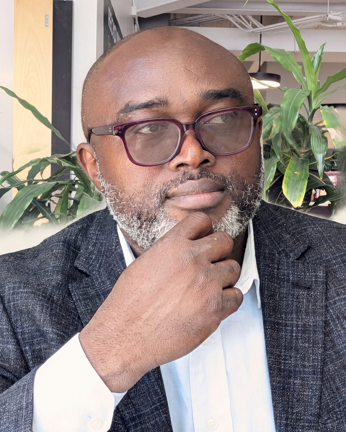 Gideon Adedokun, head and shoulders, hand at his chin in thought